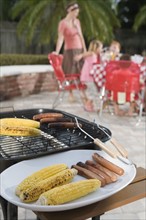 Grilled hotdogs and corn on backyard grill. Date : 2008