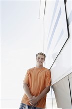 Young man leaning against motor home. Date : 2008