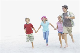 Children running on beach. Date : 2008