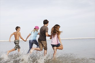Children running in ocean. Date : 2008