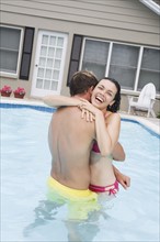 Couple hugging in swimming pool. Date : 2008
