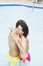 Couple hugging in swimming pool. Date : 2008