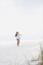 Girl twirling in beach. Date : 2008