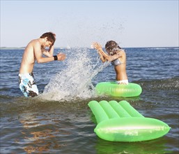 Young couple splashing in ocean. Date : 2008