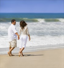 Couple walking on beach. Date : 2008