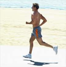 Man running on beach. Date : 2008
