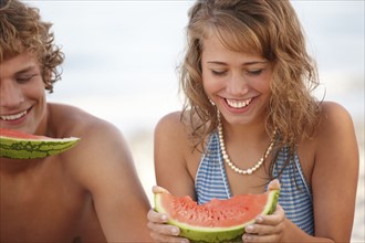 Young couple eating watermelon on beach. Date : 2008
