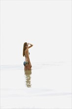 Teenage girl wading in ocean. Date : 2008