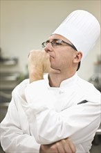 Chef in uniform concentrating. Date : 2008