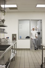 Chef standing in doorway of kitchen office. Date : 2008