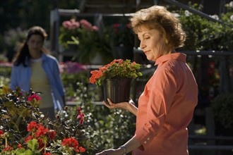 Woman shopping for flowers. Date : 2008