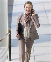 Businesswoman walking up stairs. Date : 2008