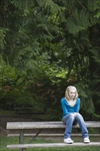 Girl sitting on park bench. Date : 2008
