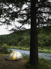 Tent and campsite by river. Date : 2008