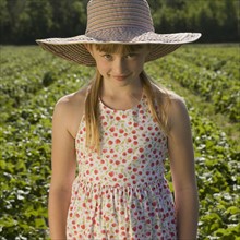 Girl standing in strawberry field. Date : 2008