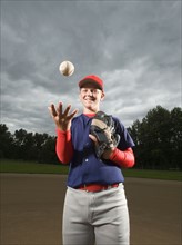 Baseball pitcher tossing ball in air. Date : 2008