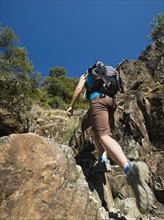 Hiker ascending rocky trail. Date : 2008