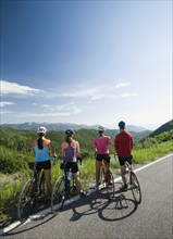 Cyclists looking at view on mountain road. Date : 2008