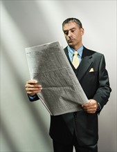 Businessman reading newspaper. Date : 2008