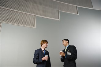 Businessmen talking during coffee break. Date : 2008