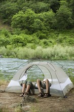Couple relaxing in tent. Date : 2008