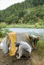 Couple preparing campsite. Date : 2008