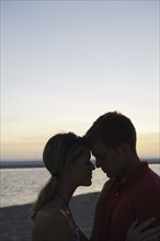 Young couple hugging on beach at sunset. Date : 2008
