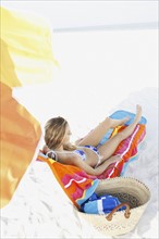 Teenage girl relaxing on beach. Date : 2008