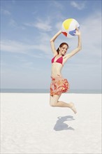 Young woman jumping with beach ball. Date : 2008