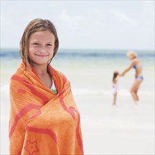 Girl wrapped in towel on beach. Date : 2008
