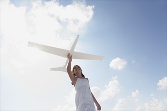Girl flying model airplane. Date : 2008