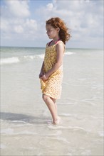 Girl wading in ocean. Date : 2008