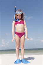 Girl on beach wearing snorkeling equipment. Date : 2008