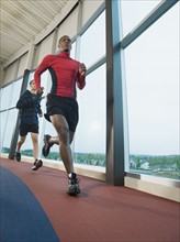 Men running on indoor track. Date: 2008