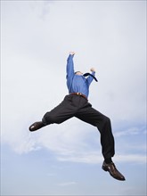Businessman jumping in mid-air. Date : 2008