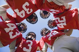 Football players in huddle. Date: 2008
