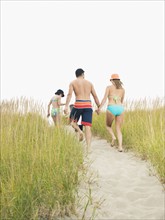 Family walking on beach. Date : 2008