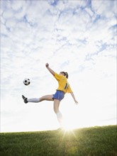 Teenage girl kicking soccer ball. Date: 2008