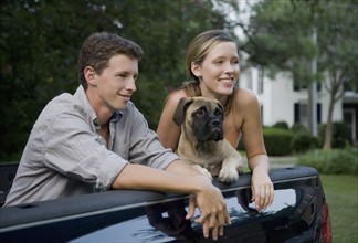 Couple and dog in back of truck. Date: 2008