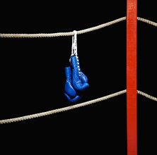Boxing gloves hanging from boxing ring. Date : 2008