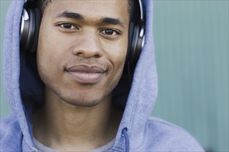 Close up portrait of young man listening to headphones. Date: 2008