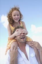 Daughter riding on father’s shoulders. Date: 2008