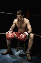 Boxer sitting on stool in corner of boxing ring. Date : 2008