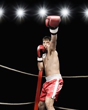 Boxer extending arm in boxing ring. Date: 2008
