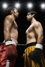 Boxers facing off in boxing ring. Date: 2008