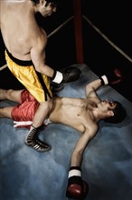 Boxer standing above knocked out opponent. Date : 2008