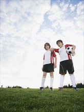 Portrait of boys in soccer uniforms holding ball. Date : 2008