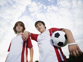 Portrait of boys in soccer uniforms holding ball. Date: 2008