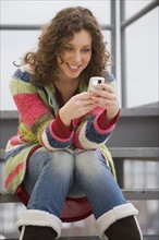 Woman text messaging on cell phone.