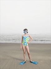 Girl on beach wearing flippers and snorkeling mask. Date: 2008